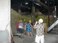 Chuck, Bob, Bill, Jeannie, guide, and Roland at the sugar cane refuse pile that is used for fuel. 2/27/03