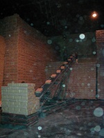Fifty pound bags of sugar being stacked in the warehouse. The floating white stuff is sugar. 2/27/03