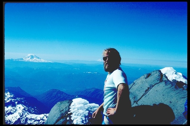 Larry Bortner on Mt. Rainier summit, showing Mts. Adam and St. Helens 1988